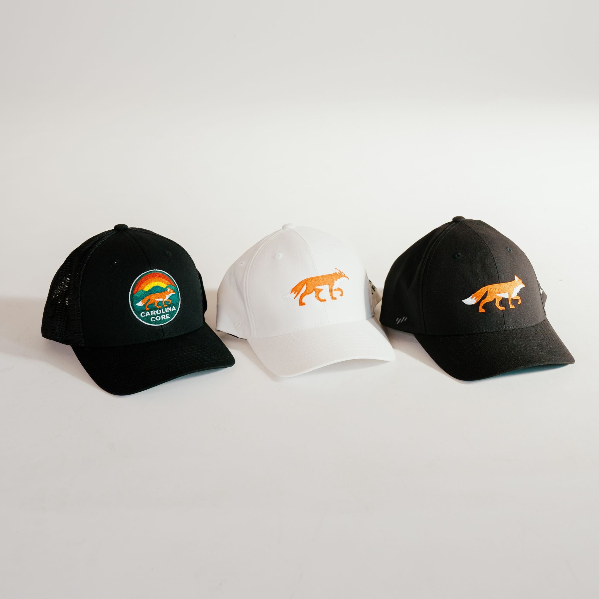 Logo Trucker hat in black, fox hat in black or white with Carolina Core FC.  Both in stretch snapbacks.